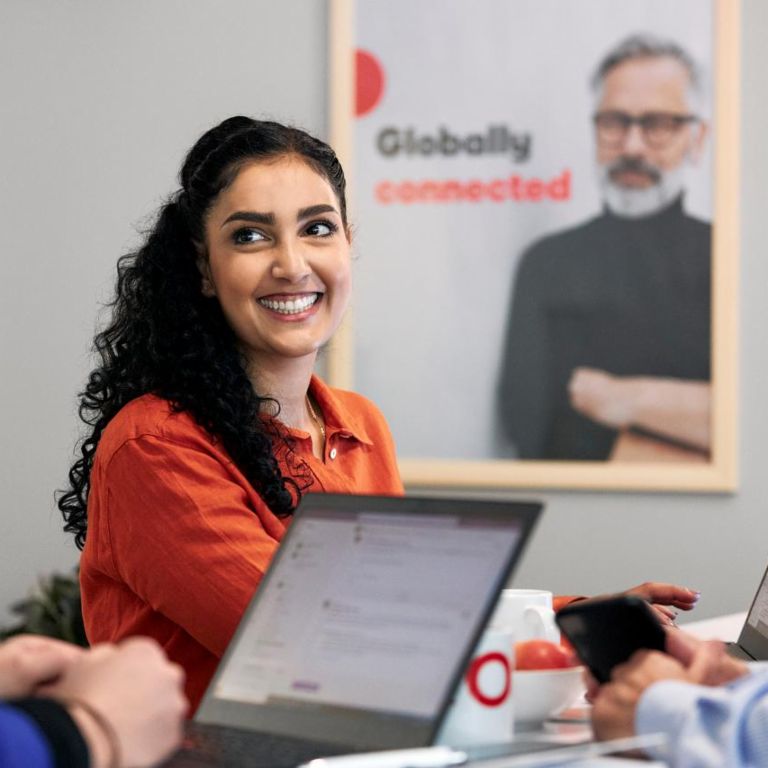 Three EOS colleagues working together, woman in focus.